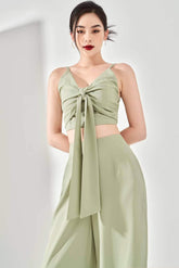 Silk crop top with twist-knot front and spaghetti straps, featuring back smocking detail